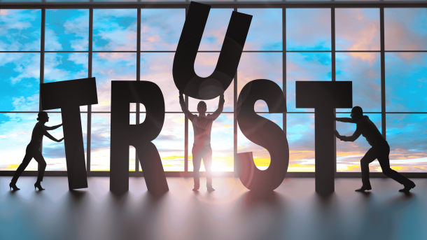Team of professionals building the word "trust"